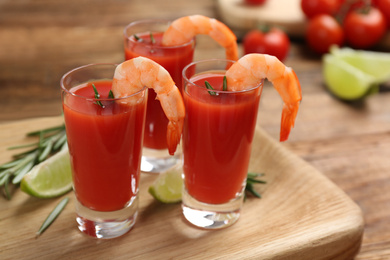 Photo of Shrimp cocktail with tomato sauce served on wooden board