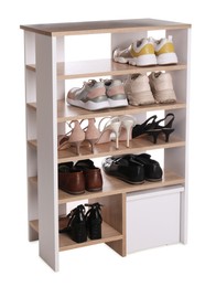 Stylish shelving unit with different pairs of shoes on white background. Storage idea