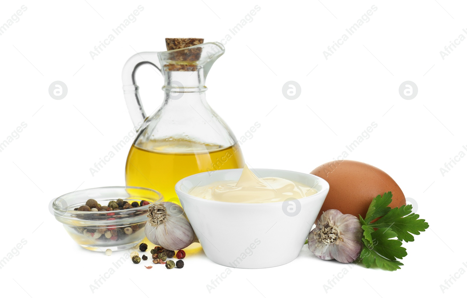 Photo of Fresh mayonnaise sauce in bowl and ingredients isolated on white