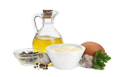 Photo of Fresh mayonnaise sauce in bowl and ingredients isolated on white