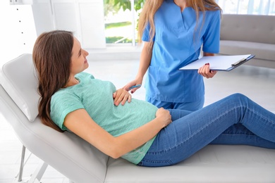 Young pregnant woman with her doctor in clinic