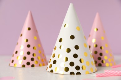 Birthday party hats and candles on light table