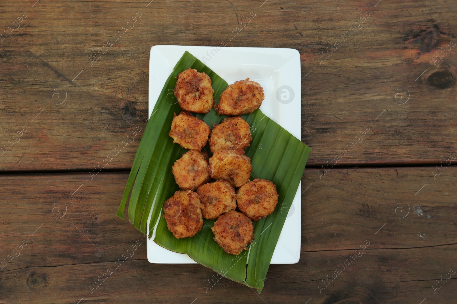 Photo of Delicious fried bananas on wooden table, top view