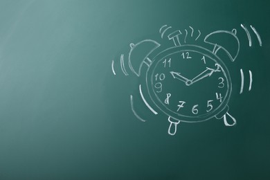 Photo of Drawn alarm clock on green chalkboard, space for text. School time