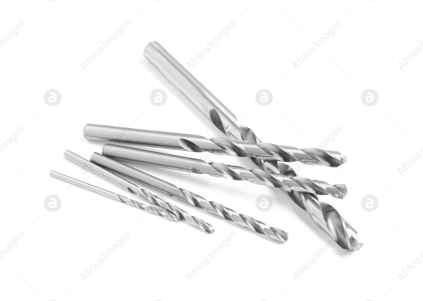 Photo of Many twist drill bits isolated on white. Carpenter's tools