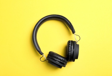 Photo of Stylish headphones on color background, top view