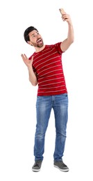 Photo of Happy man taking selfie with smartphone on white background