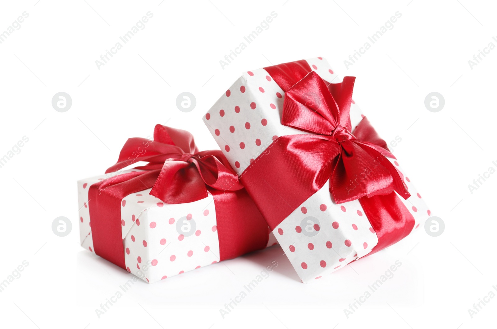 Photo of Beautifully wrapped gift boxes on white background