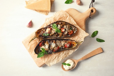 Flat lay composition with stuffed eggplants on light table