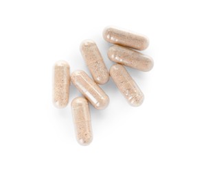 Photo of Many transparent gelatin capsules on white background, top view