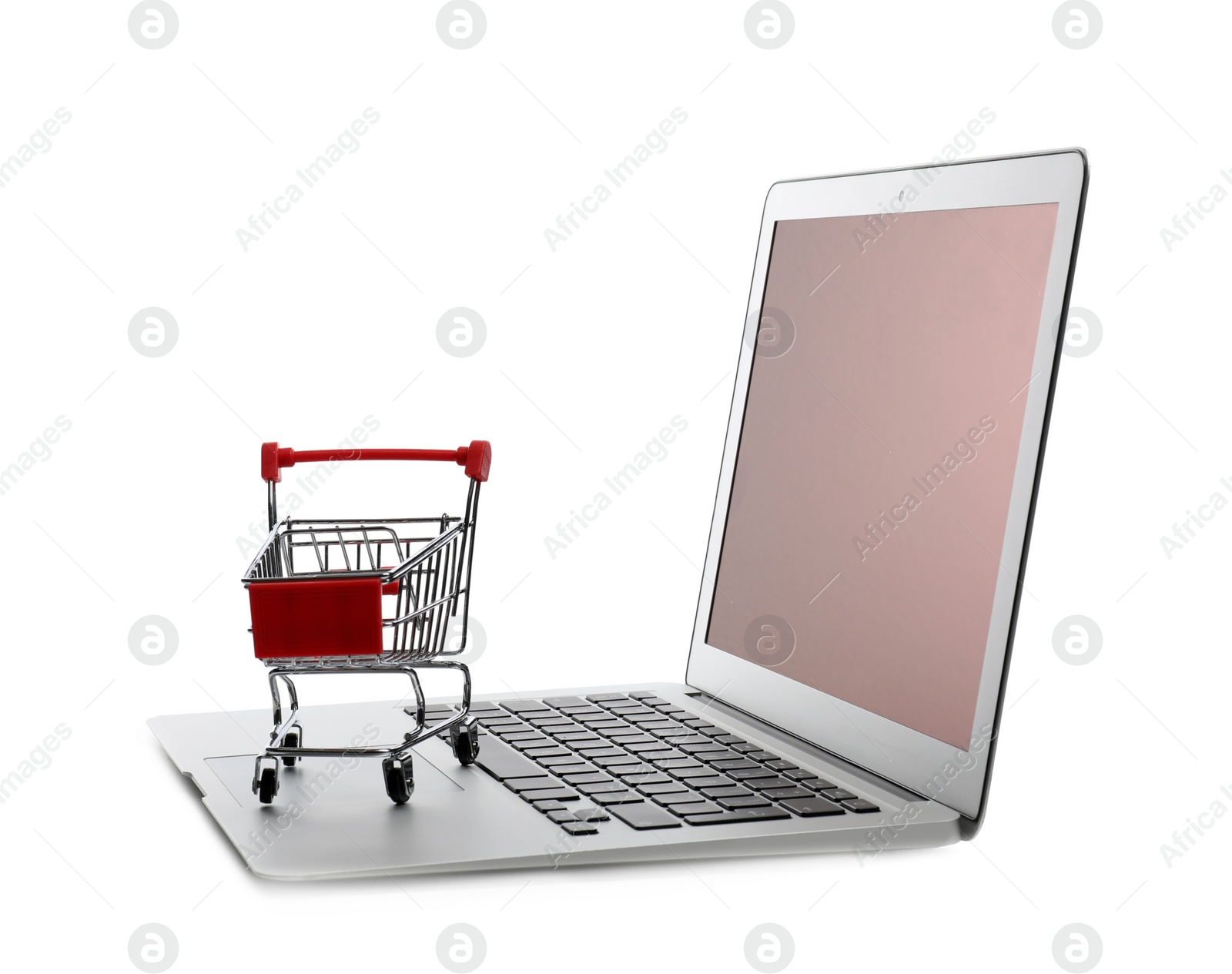 Photo of Internet shopping. Laptop with small cart isolated on white