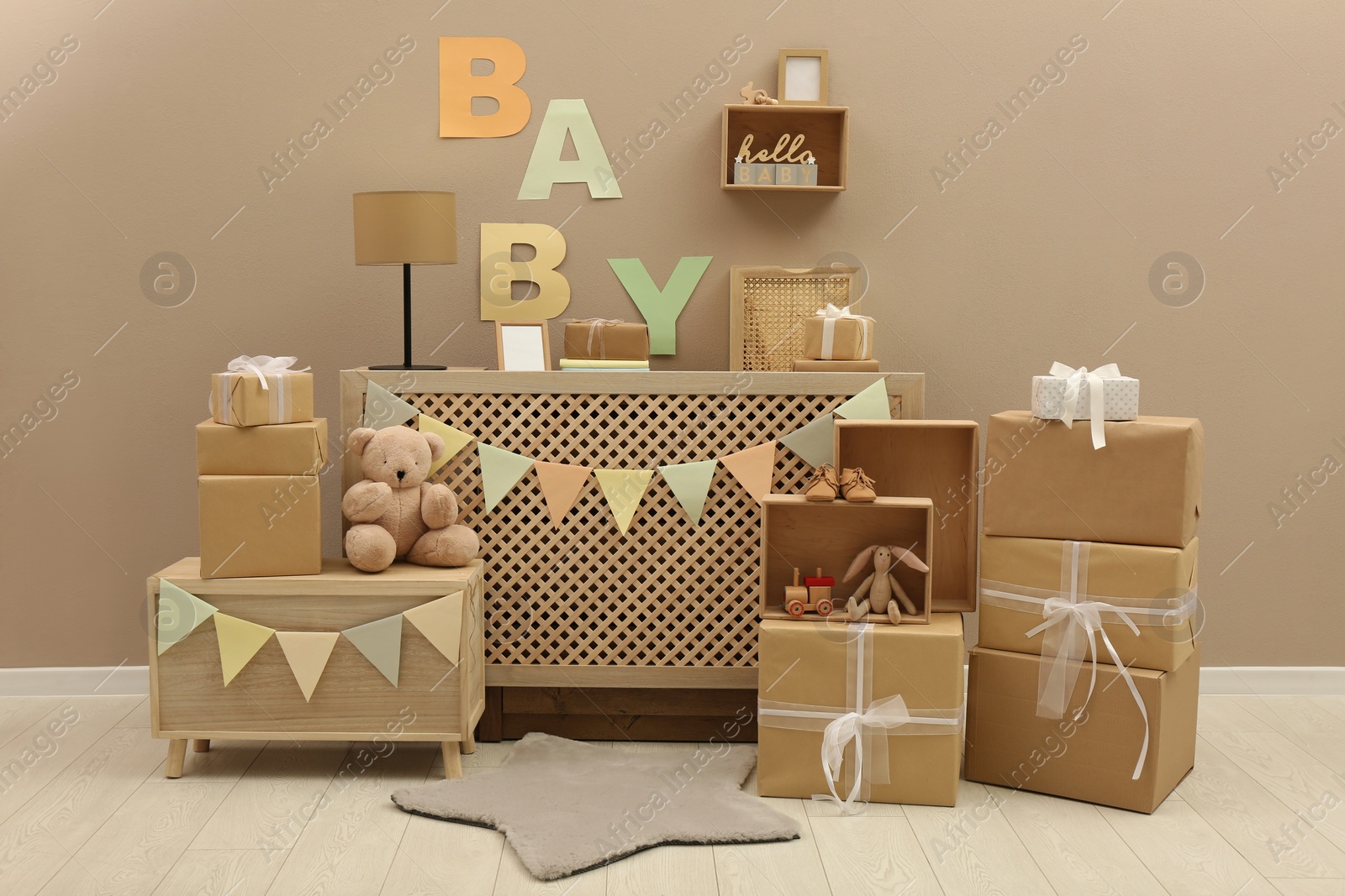 Photo of Gift boxes and toys in room decorated for baby shower party