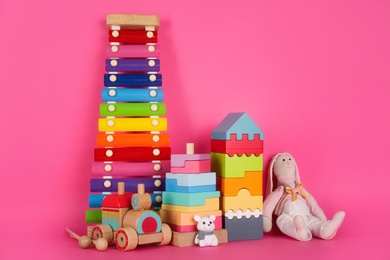 Photo of Set of different toys on pink background