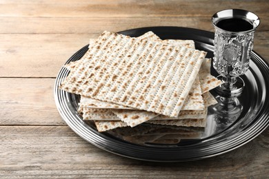 Photo of Traditional matzos and red wine on wooden table