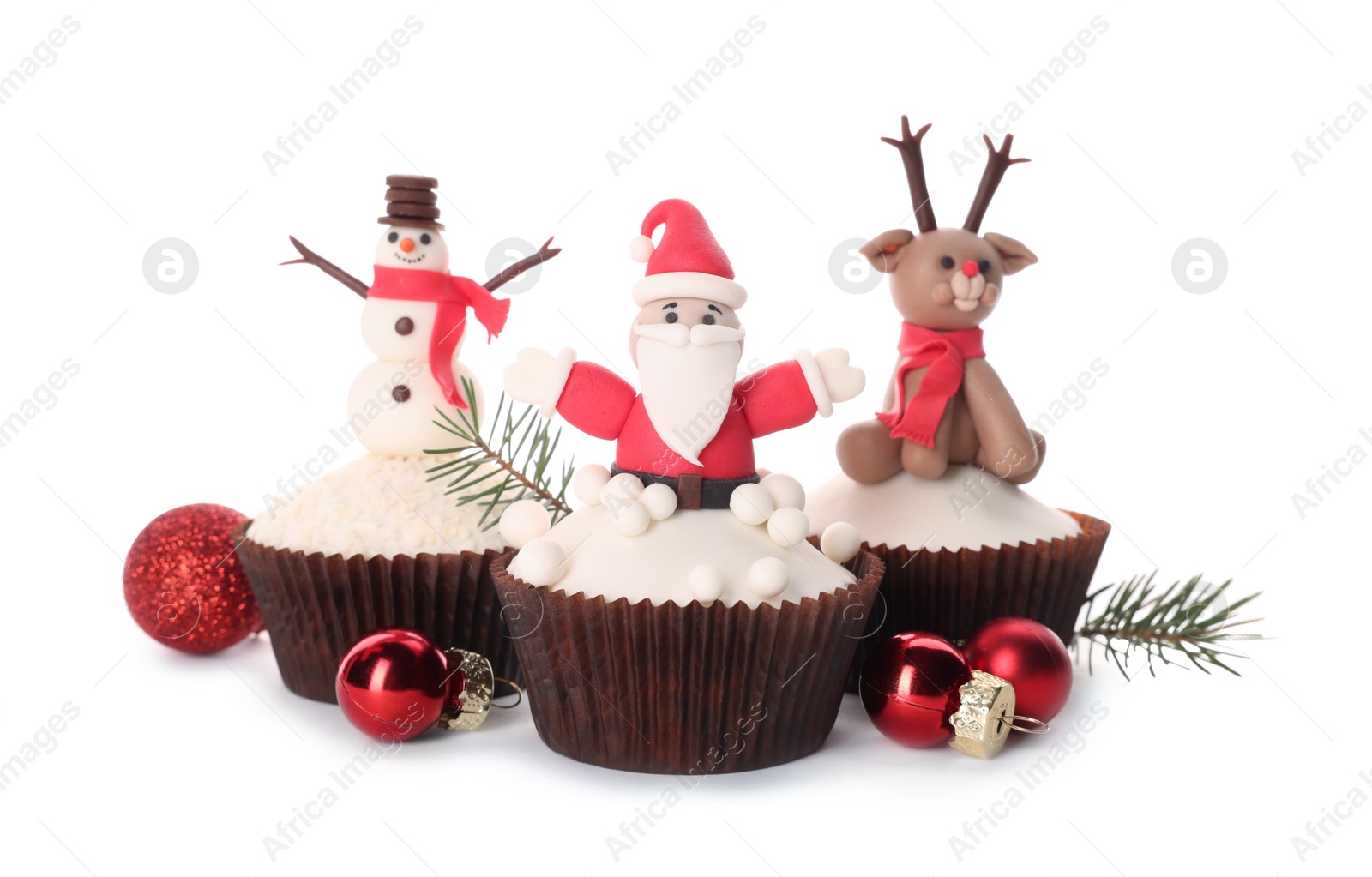 Photo of Tasty Christmas cupcakes and festive decor on white background