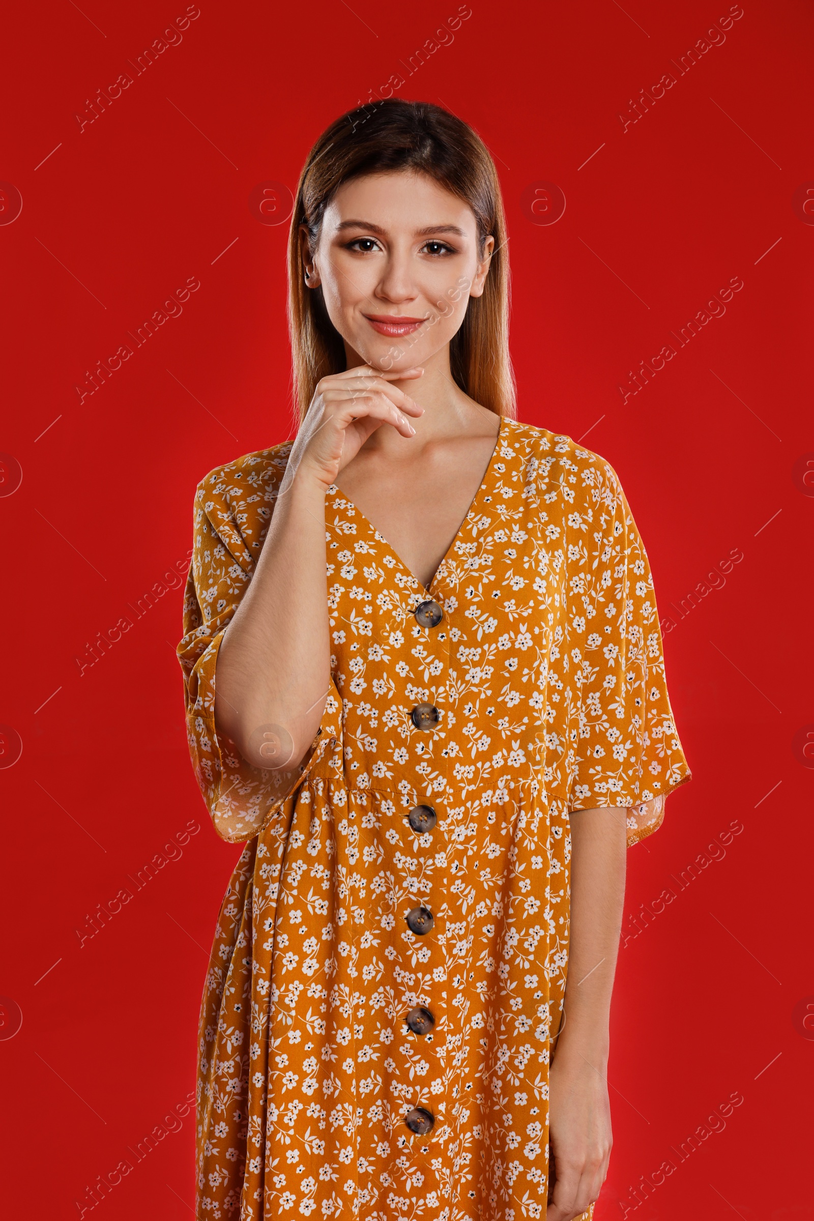 Photo of Portrait of young woman on red background