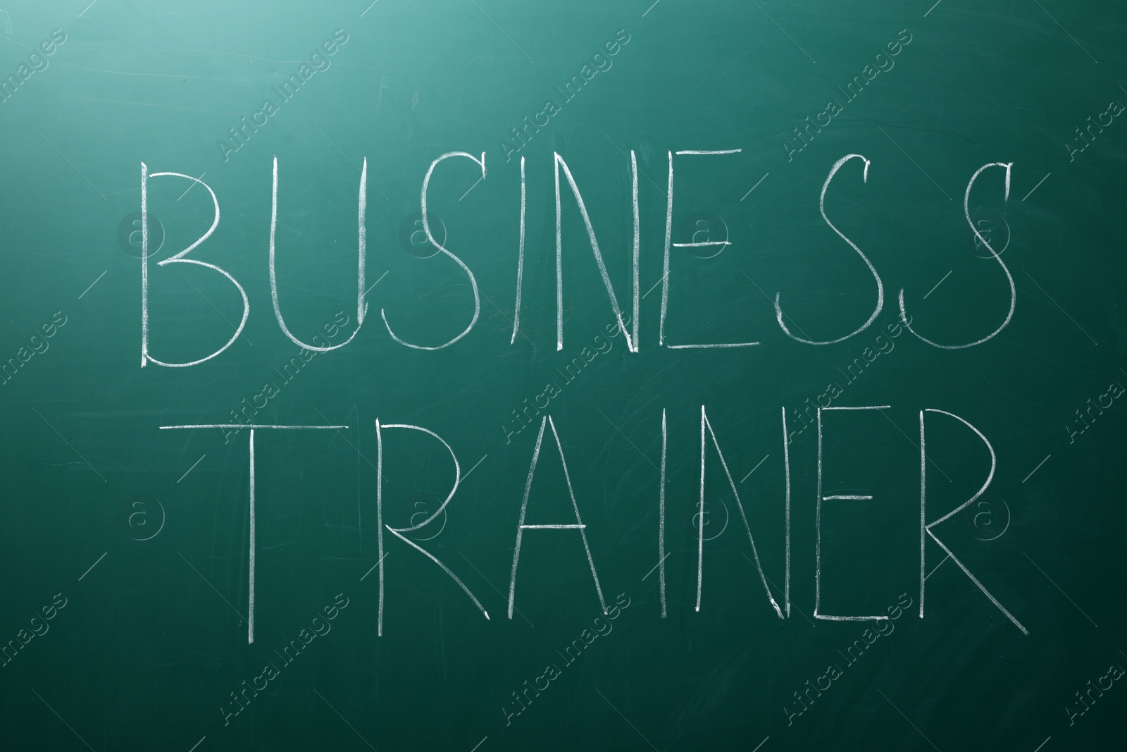 Photo of Text BUSINESS TRAINER written on chalkboard. Coaching concept
