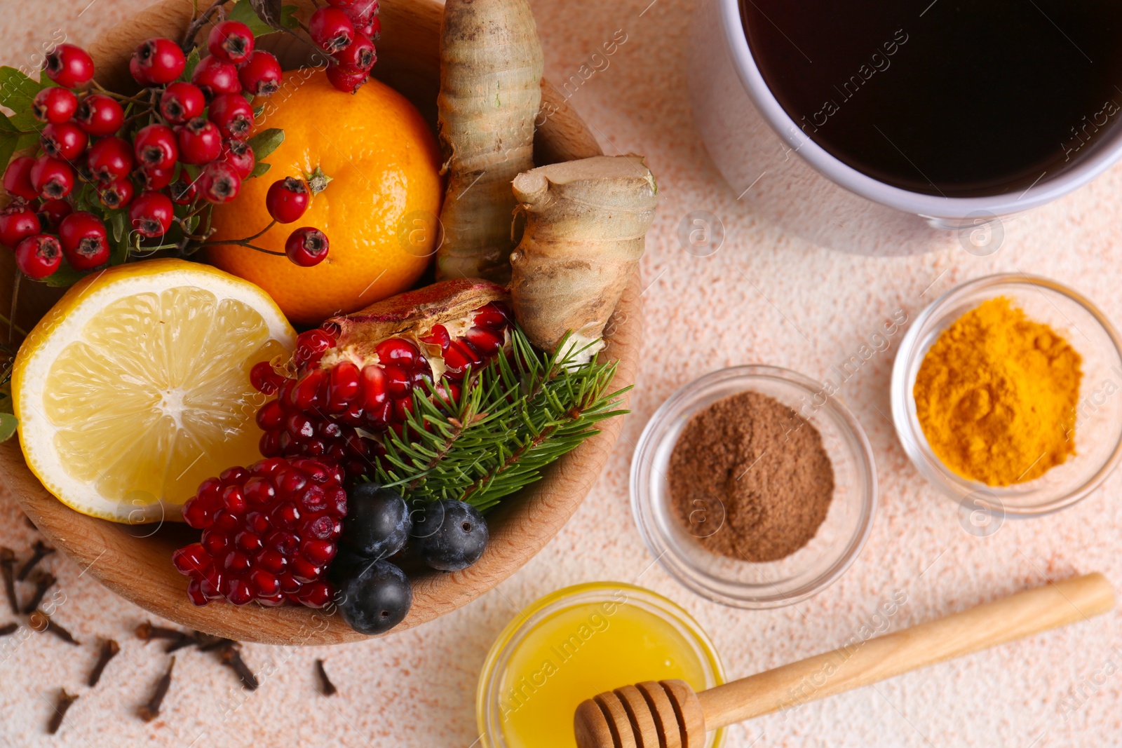 Photo of Flat lay composition with cup of delicious immunity boosting tea and ingredients on color textured background