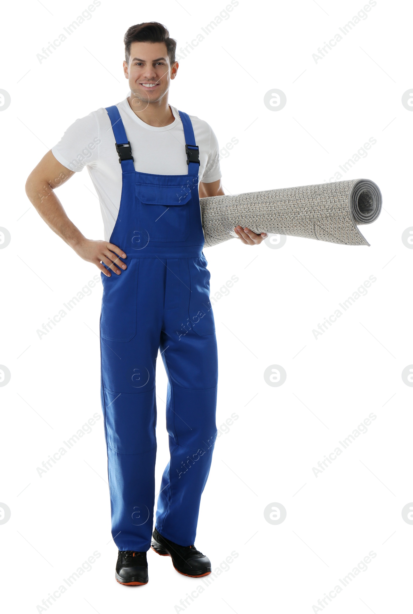 Photo of Male worker with rolled carpet on white background