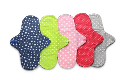 Many cloth menstrual pads on white background, top view. Reusable female hygiene product