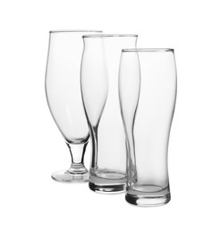 Photo of Different clean empty glasses isolated on white