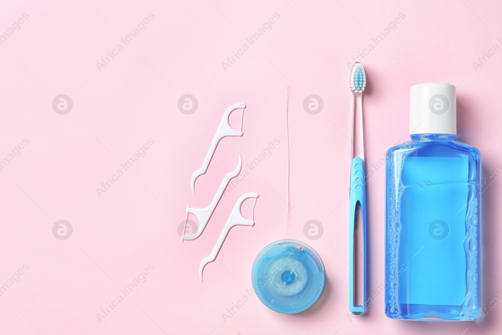 Photo of Flat lay composition with manual toothbrush and oral hygiene products on color background