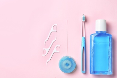 Photo of Flat lay composition with manual toothbrush and oral hygiene products on color background