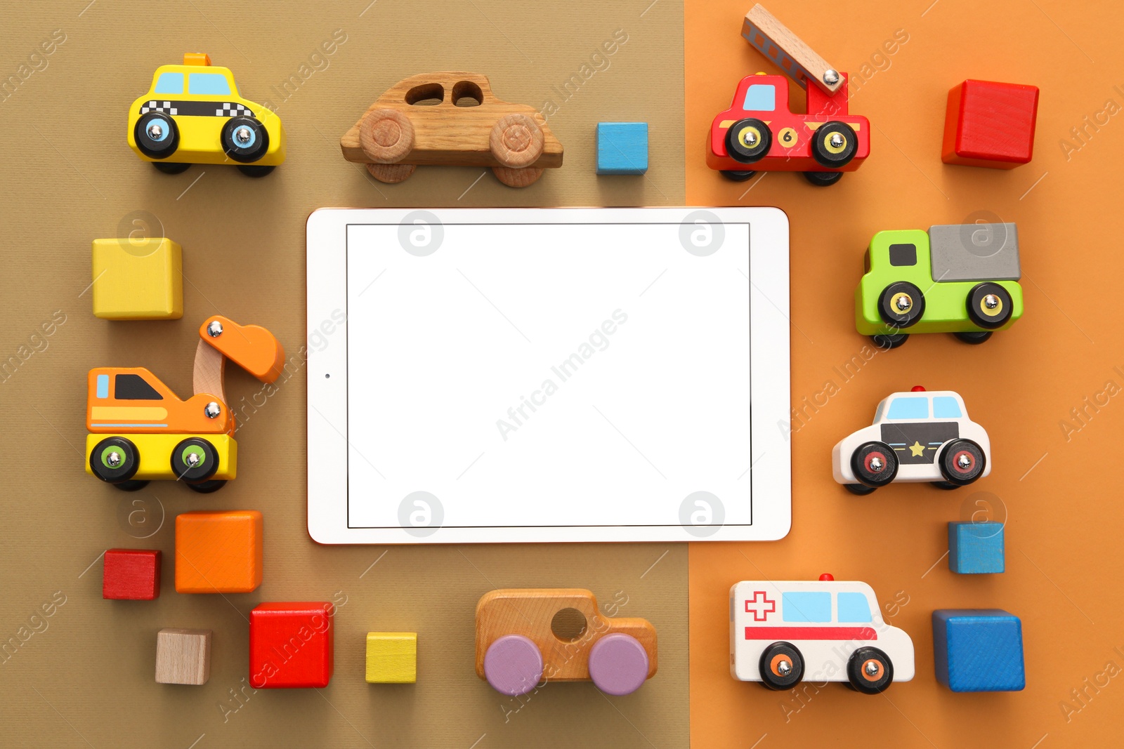 Photo of Modern tablet and toys on color background, flat lay. Space for text