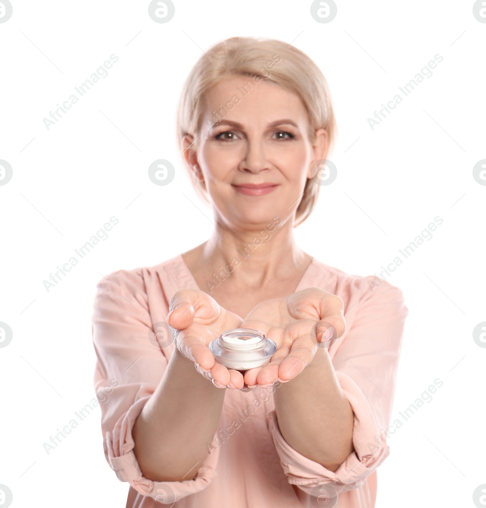 Photo of Mature woman with jar of anti-aging face cream on white background