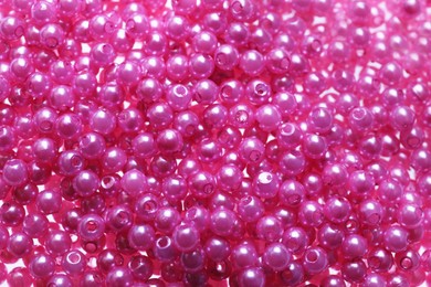 Photo of Pile of pink beads as background, closeup