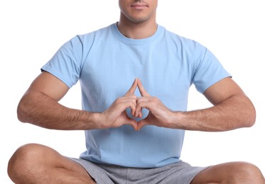 Photo of Man meditating on white background, closeup. Harmony and zen