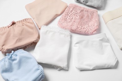 Photo of Stylish folded women's underwear on white background