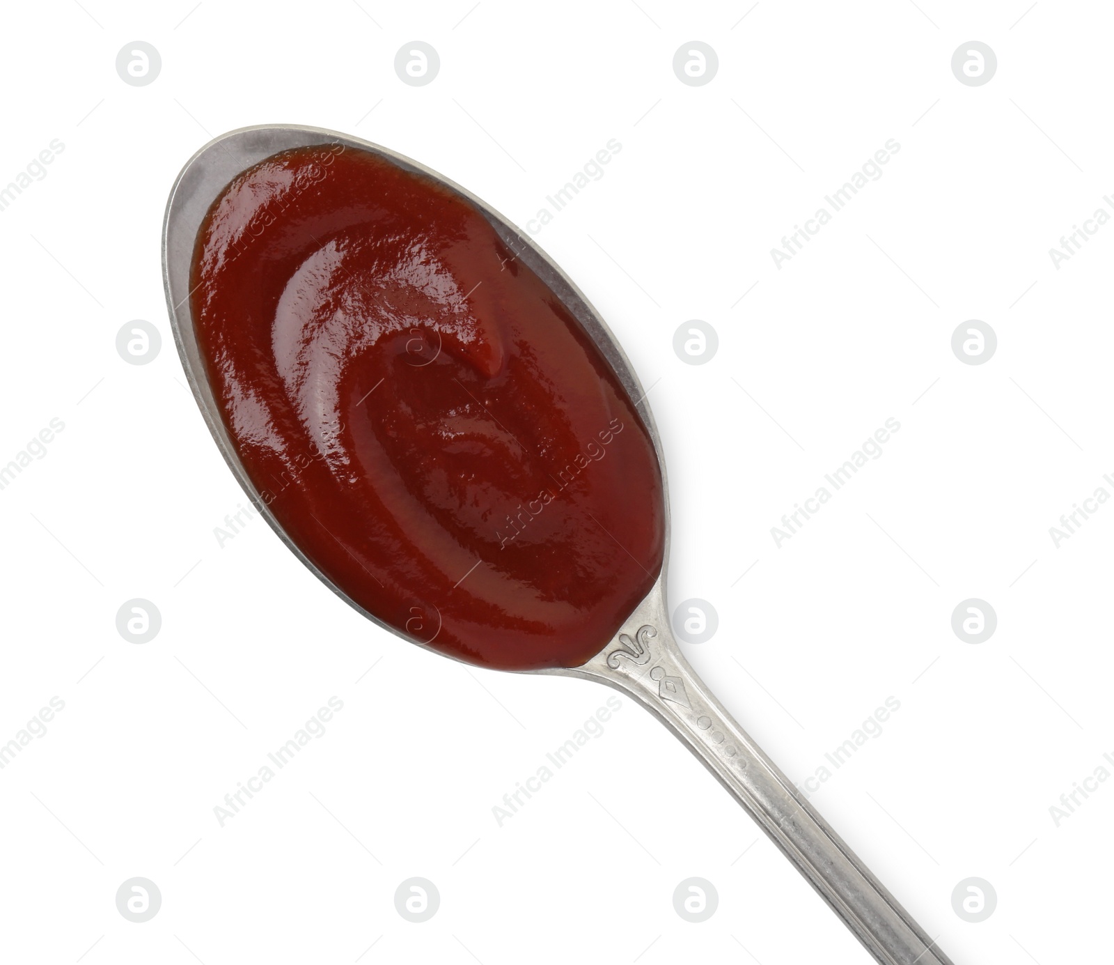 Photo of Tasty barbecue sauce in spoon isolated on white, top view