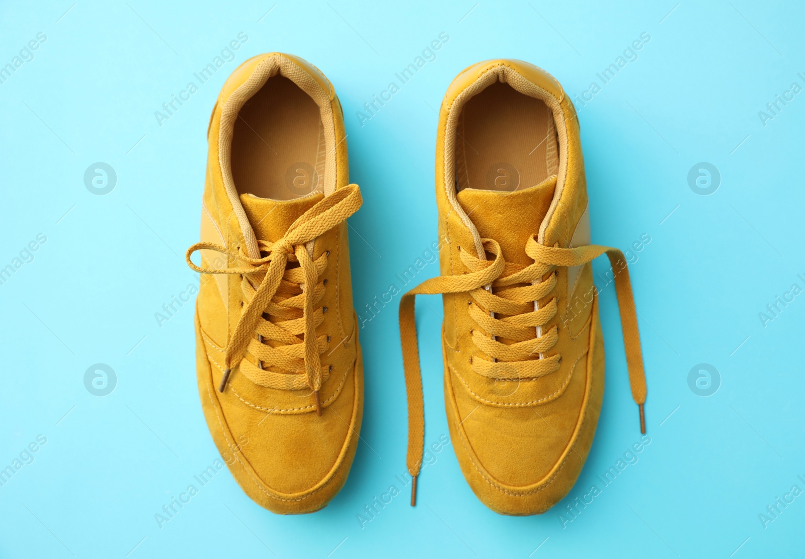 Photo of Pair of stylish shoes on light blue background, top view