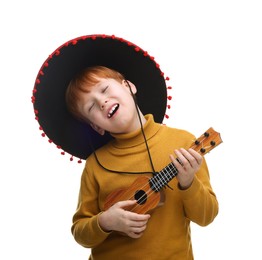 Cute boy in Mexican sombrero hat playing ukulele and singing on white background