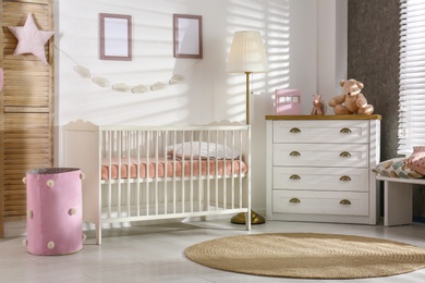 Cozy baby room interior with comfortable crib