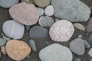 Many different pebbles as background, top view