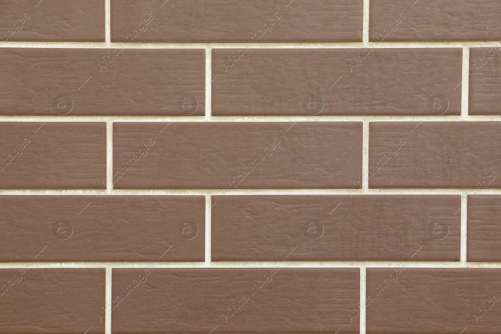 Photo of Texture of brown brick wall tiles as background