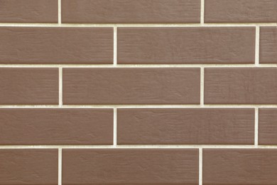 Texture of brown brick wall tiles as background