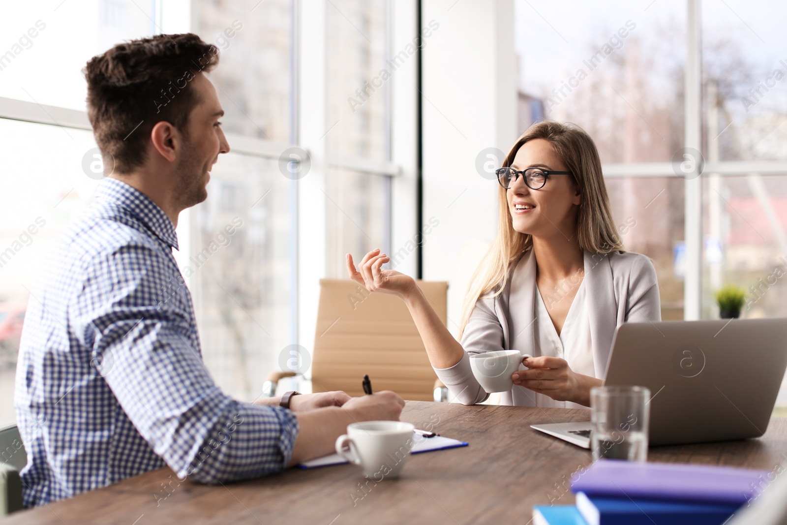 Photo of Human resources manager conducting job interview with applicant in office