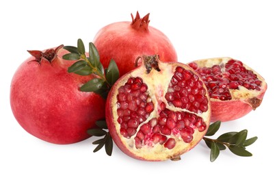 Fresh pomegranates and branches isolated on white