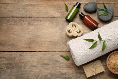Photo of Flat lay spa composition with skin care products on wooden table, space for text