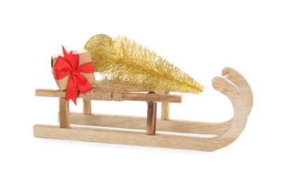 Photo of Wooden sleigh with decorative fir tree and present on white background. Christmas holidays