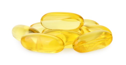 Many yellow vitamin capsules isolated on white