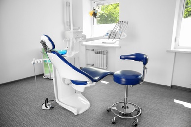 Photo of Dentist's office interior with modern chair and equipment