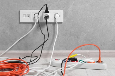 Extension cord with power plugs in sockets indoors, space for text