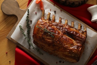 Delicious roasted ribs served on wooden table, flat lay