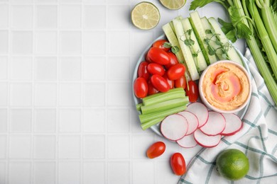 Photo of Plate with delicious hummus and fresh vegetables on white table, flat lay. Space for text