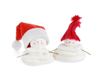 Photo of Cute decorative snowmen in red hats isolated on white