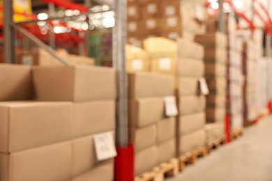 Photo of Blurred view of warehouse with boxes. Wholesaling